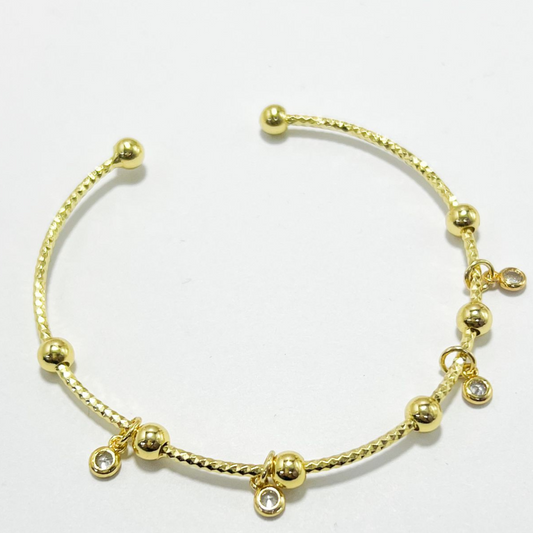 BRAZALETE CON DIJES EN CIRCONES COVER GOLD (RODIO)