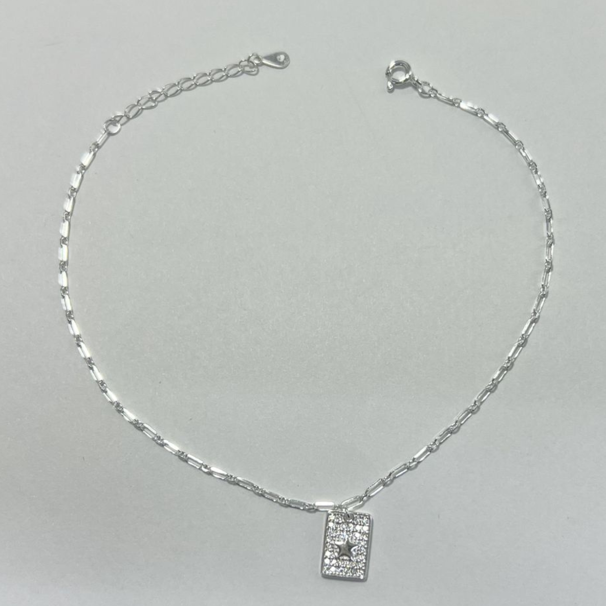 TOBILLERA EN PLATA CON DIJES EN MICRO CIRCONES